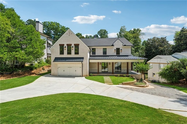 view of front of home featuring concrete driveway, an attached garage, a standing seam roof, metal roof, and a front lawn