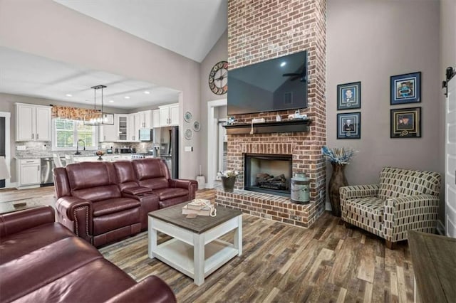 1423 Hillcrest Rd, Bowdon, GA 30108 - living room with wood finished floors, a fireplace, and high vaulted ceiling