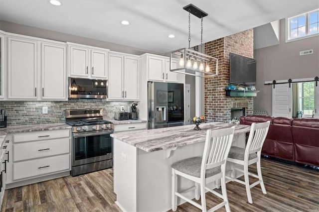 1423 Hillcrest Rd, Bowdon, GA 30108 - kitchen with stainless steel appliances, dark wood-style flooring, healthy amount of natural light, open floor plan, and recessed lighting