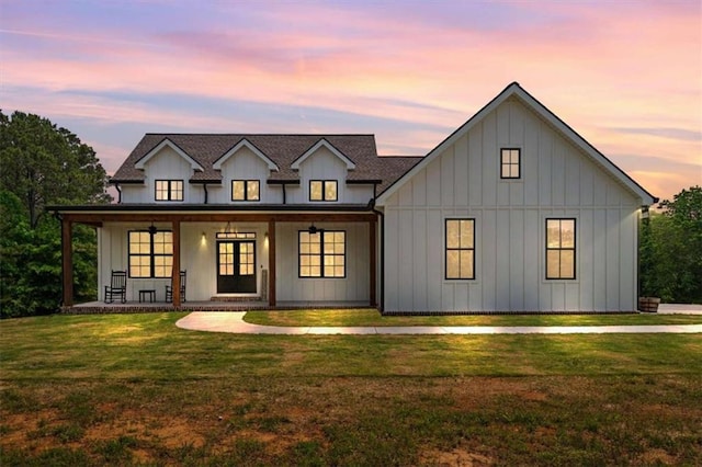 1423 Hillcrest Rd, Bowdon, GA 30108 - view of front of house with covered porch, a front lawn, board and batten siding, and french doors