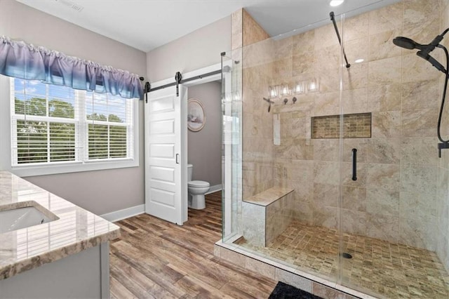 1423 Hillcrest Rd, Bowdon, GA 30108 - bathroom with a stall shower, wood finished floors, toilet, and vanity