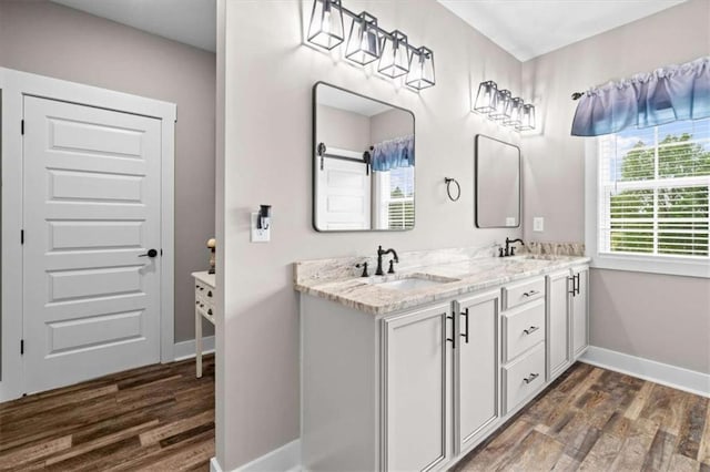 1423 Hillcrest Rd, Bowdon, GA 30108 - bathroom featuring wood finished floors, baseboards, and double vanity