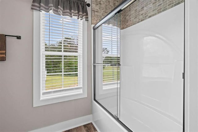 1423 Hillcrest Rd, Bowdon, GA 30108 - full bathroom with baseboards, plenty of natural light, combined bath / shower with glass door, and wood finished floors