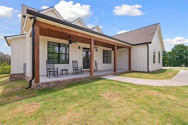 1423 Hillcrest Rd, Bowdon, GA 30108 - view of front of home featuring board and batten siding, a ceiling fan, a front lawn, a porch, and roof with shingles