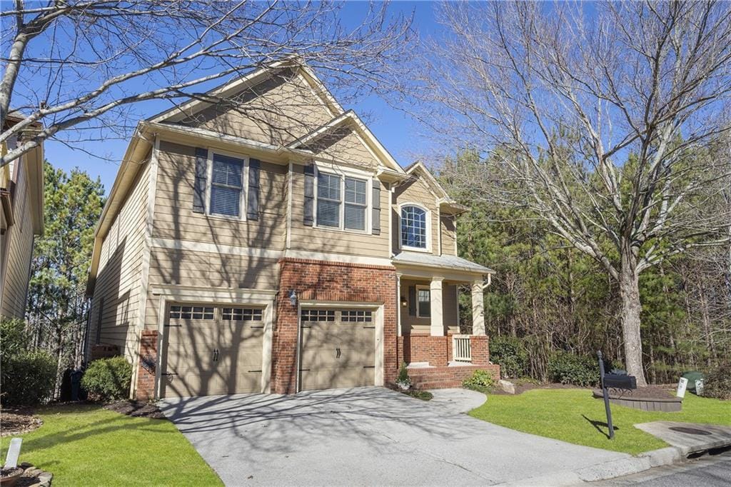 craftsman house with a garage and a front lawn