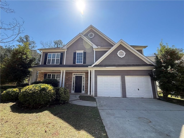 2728 Sandalwood Cir, Locust Grove, GA 30248 - view of front of home with a front lawn, stone siding, covered porch, and driveway