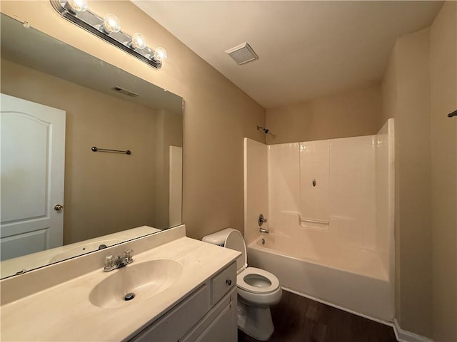 2728 Sandalwood Cir, Locust Grove, GA 30248 - bathroom featuring visible vents, toilet, wood finished floors, and bathing tub / shower combination