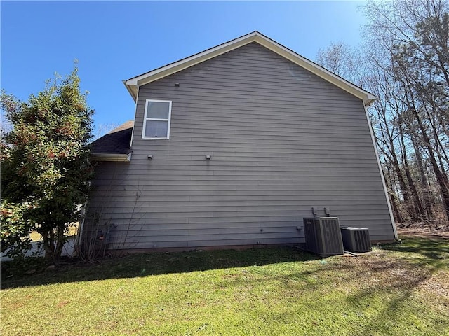 2728 Sandalwood Cir, Locust Grove, GA 30248 - view of property exterior with central AC unit, a lawn, and a shingled roof
