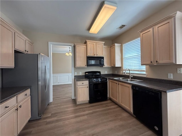 2728 Sandalwood Cir, Locust Grove, GA 30248 - kitchen with visible vents, black appliances, a sink, dark countertops, and wood finished floors