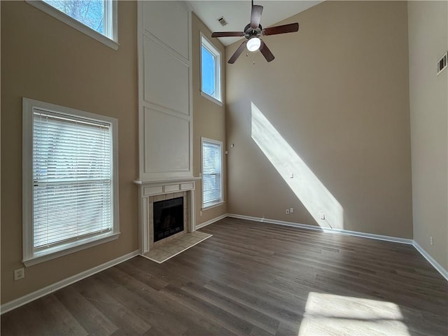 2728 Sandalwood Cir, Locust Grove, GA 30248 - unfurnished living room featuring dark wood finished floors, plenty of natural light, visible vents, and ceiling fan