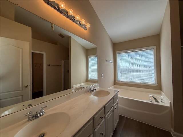 2728 Sandalwood Cir, Locust Grove, GA 30248 - full bath with a sink, lofted ceiling, and a garden tub
