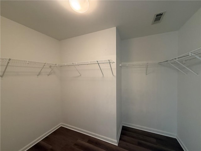 2728 Sandalwood Cir, Locust Grove, GA 30248 - walk in closet featuring dark wood-type flooring and visible vents