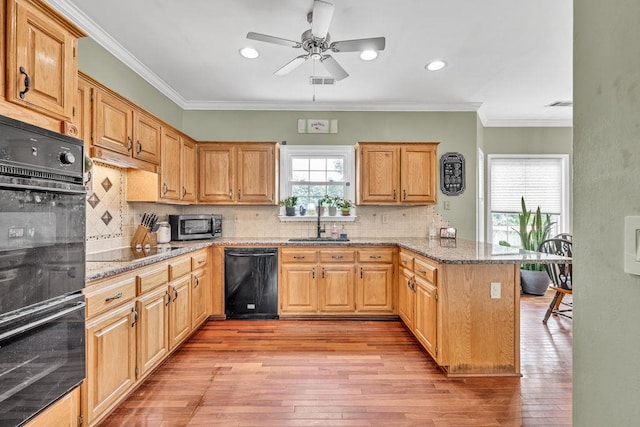 422 Inwood Trl, Lawrenceville, GA 30043 - kitchen featuring black appliances, a peninsula, a sink, light wood-type flooring, and ornamental molding