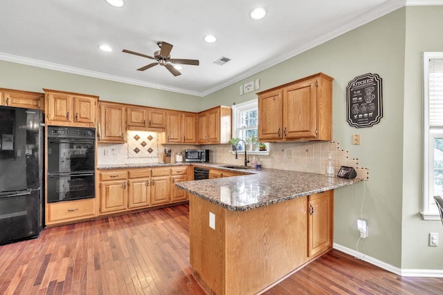 422 Inwood Trl, Lawrenceville, GA 30043 - kitchen featuring black appliances, a sink, hardwood / wood-style flooring, stone countertops, and ceiling fan