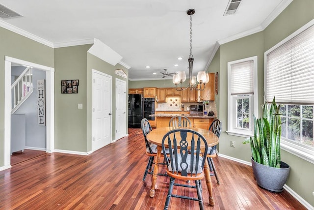 422 Inwood Trl, Lawrenceville, GA 30043 - dining area with crown molding, dark wood finished floors, baseboards, a chandelier, and recessed lighting