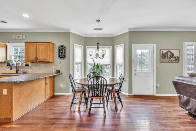 422 Inwood Trl, Lawrenceville, GA 30043 - dining space with a chandelier, dark wood-type flooring, baseboards, ornamental molding, and recessed lighting