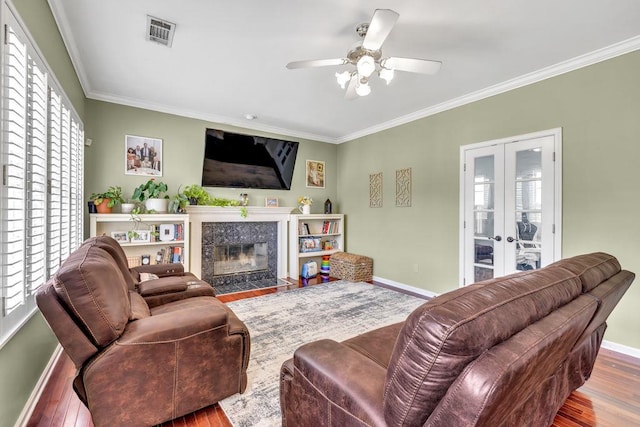 422 Inwood Trl, Lawrenceville, GA 30043 - living room with wood finished floors, crown molding, baseboards, a high end fireplace, and a ceiling fan