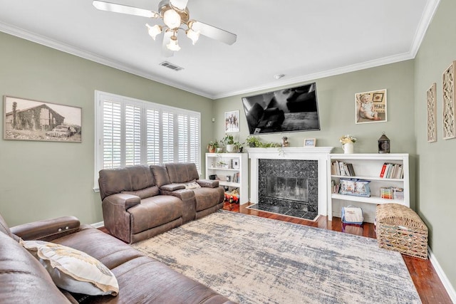 422 Inwood Trl, Lawrenceville, GA 30043 - living area featuring a ceiling fan, wood finished floors, ornamental molding, a tiled fireplace, and baseboards