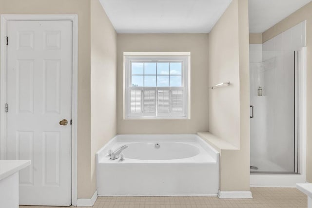 422 Inwood Trl, Lawrenceville, GA 30043 - bathroom with a stall shower, a bath, baseboards, and tile patterned floors