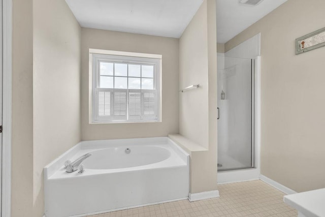 422 Inwood Trl, Lawrenceville, GA 30043 - bathroom featuring a bath, a shower stall, and baseboards