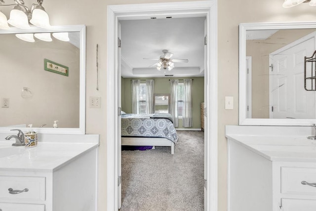 422 Inwood Trl, Lawrenceville, GA 30043 - ensuite bathroom with vanity, a ceiling fan, and a raised ceiling