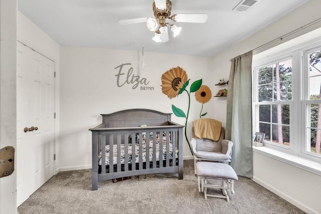422 Inwood Trl, Lawrenceville, GA 30043 - carpeted bedroom with a crib, baseboards, and ceiling fan