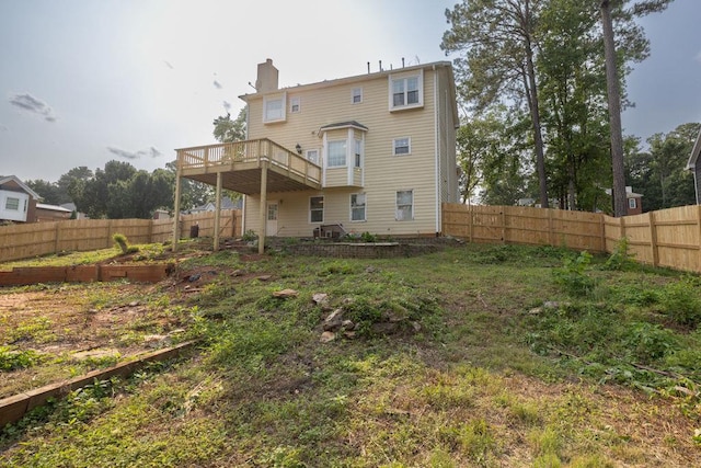422 Inwood Trl, Lawrenceville, GA 30043 - rear view of house featuring a chimney, a fenced backyard, a wooden deck, and a garden