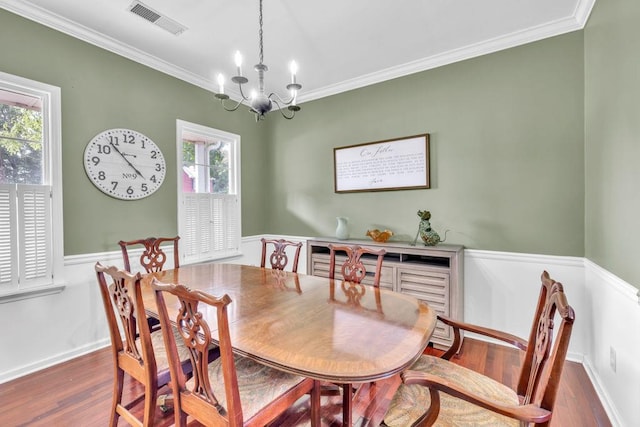 422 Inwood Trl, Lawrenceville, GA 30043 - dining area with dark wood-style flooring, ornamental molding, a chandelier, and baseboards