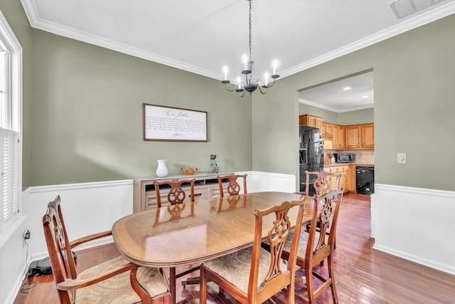 422 Inwood Trl, Lawrenceville, GA 30043 - dining area featuring light wood-type flooring, crown molding, a chandelier, and recessed lighting