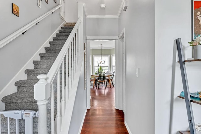 422 Inwood Trl, Lawrenceville, GA 30043 - stairway featuring crown molding, wood finished floors, a chandelier, and baseboards