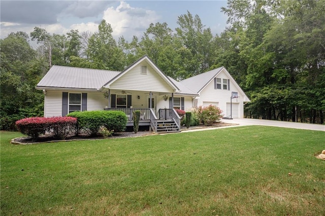 view of front of house with metal roof, a porch, a garage, concrete driveway, and a front yard