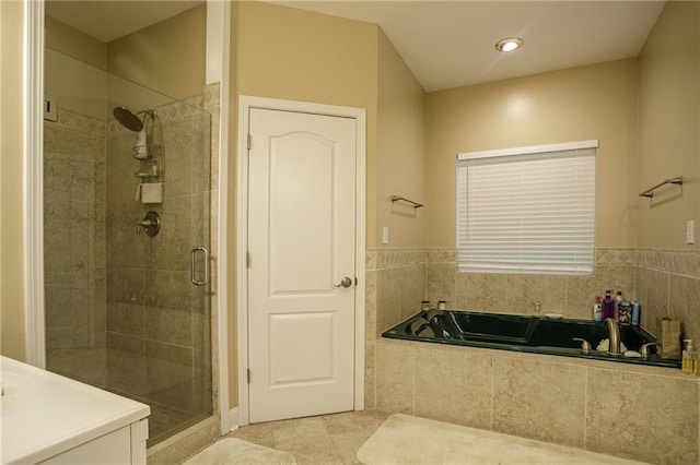 bathroom featuring a garden tub, a shower stall, and tile patterned flooring