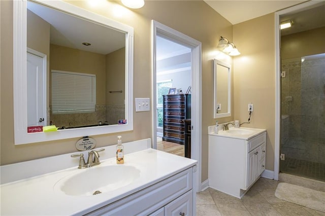 bathroom featuring a stall shower, two vanities, a sink, and tile patterned floors