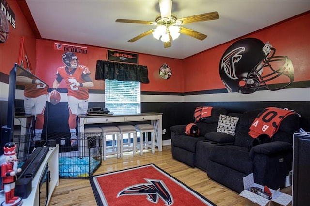 living room with ceiling fan and wood finished floors