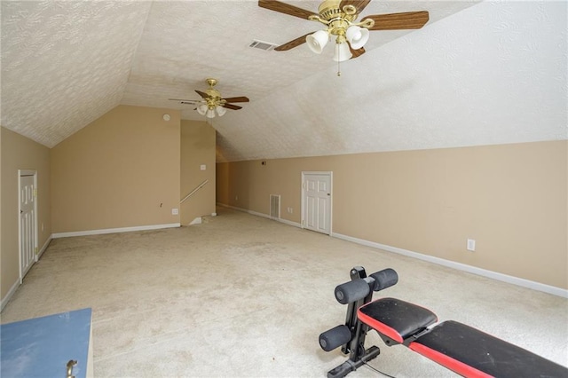 additional living space with lofted ceiling, carpet, visible vents, and a textured ceiling