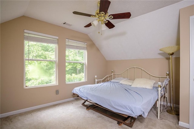 carpeted bedroom with vaulted ceiling, ceiling fan, visible vents, and baseboards