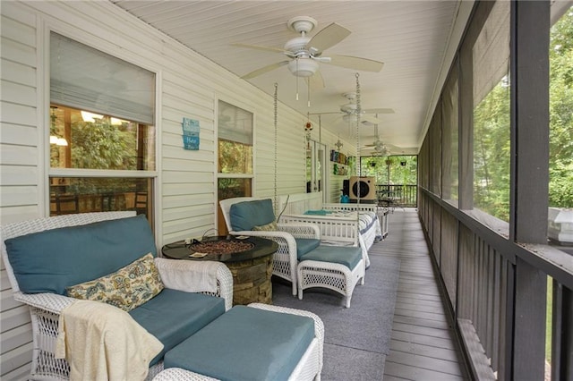 sunroom / solarium with a ceiling fan