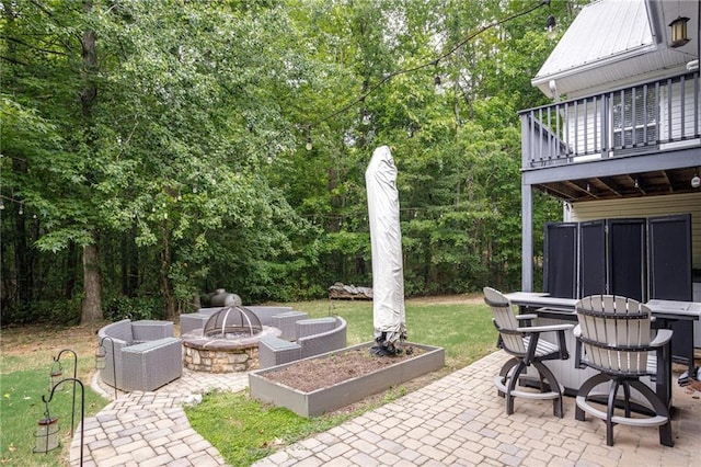 view of patio / terrace featuring a fire pit, outdoor dining space, and area for grilling