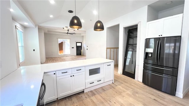 kitchen with fridge with ice dispenser, white cabinetry, ceiling fan, decorative light fixtures, and vaulted ceiling