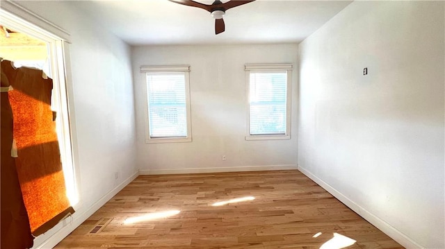 spare room featuring ceiling fan and light hardwood / wood-style flooring