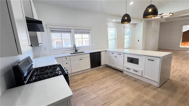 kitchen with kitchen peninsula, sink, black appliances, pendant lighting, and white cabinets