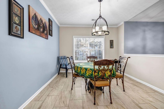 dining room with ornamental molding and a chandelier