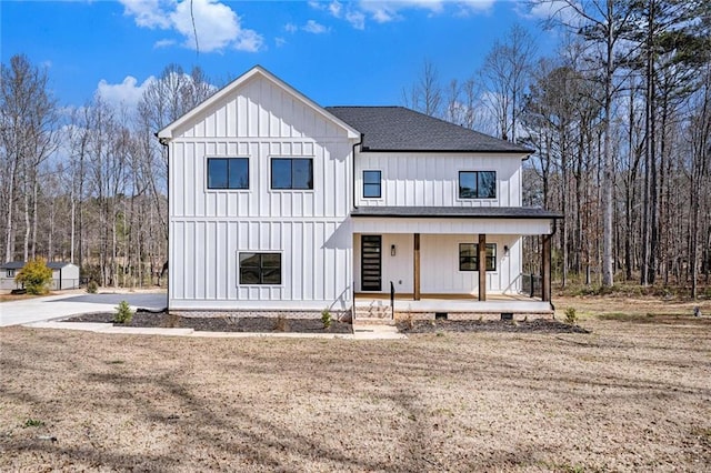 modern inspired farmhouse with covered porch, roof with shingles, and board and batten siding