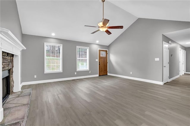 unfurnished living room with a ceiling fan, wood finished floors, a fireplace, and baseboards