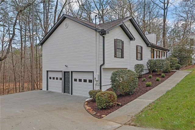 view of property exterior featuring a garage and driveway