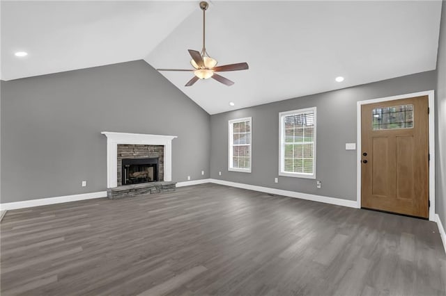 unfurnished living room featuring dark wood-style floors, a fireplace, baseboards, and lofted ceiling