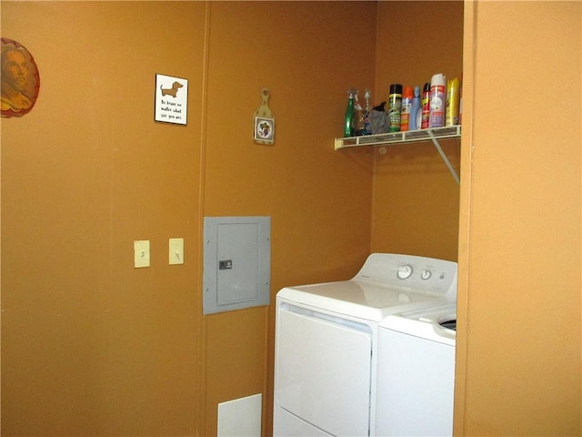 washroom with washing machine and clothes dryer and electric panel