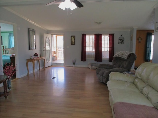 living room featuring ornamental molding, a healthy amount of sunlight, ceiling fan, and light hardwood / wood-style floors