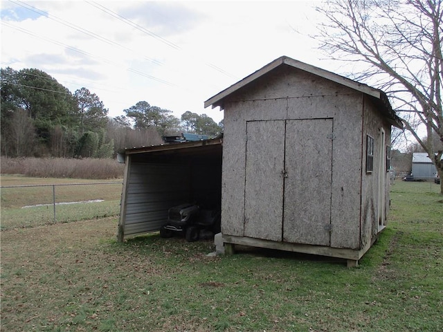 view of outbuilding featuring a lawn