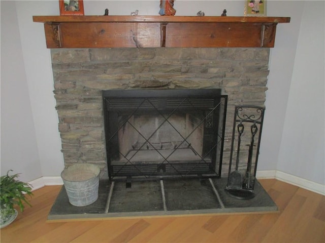 interior details featuring hardwood / wood-style flooring and a fireplace